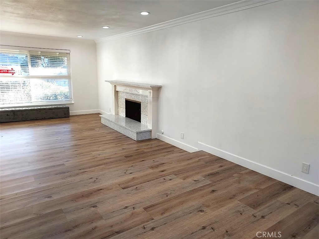 8803 Hummingbird Avenue Fountain Valley, CA 92708 - Photo 10 of 43 a view of empty room with wooden floor and fireplace