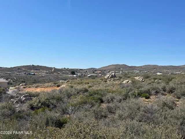 a view of a mountain range in a cloudy sky