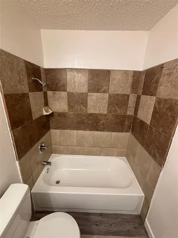 a bathroom with a bathtub and toilet