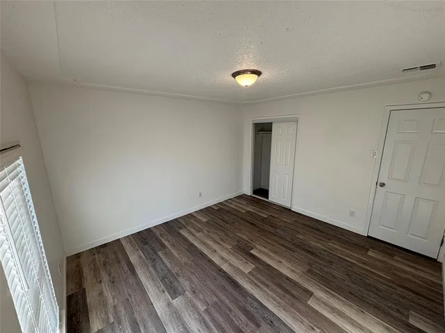 a view of a room with wooden floor and carpet