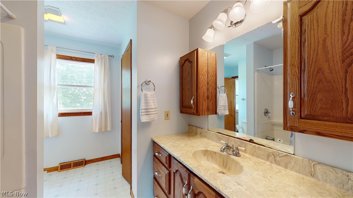 3394 Waterloo Road Mogadore, OH 44260 - Photo 15 of 40 Bathroom featuring tile flooring, a textured ceiling, and vanity