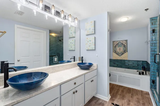 a bathroom with a bathtub and shower