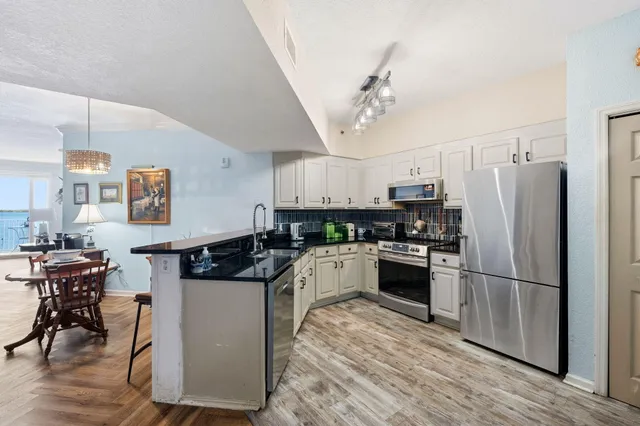 a kitchen with granite countertop a sink and cabinets