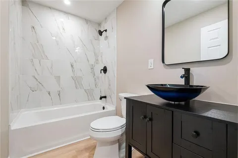 a bathroom with a sink a toilet and bathtub