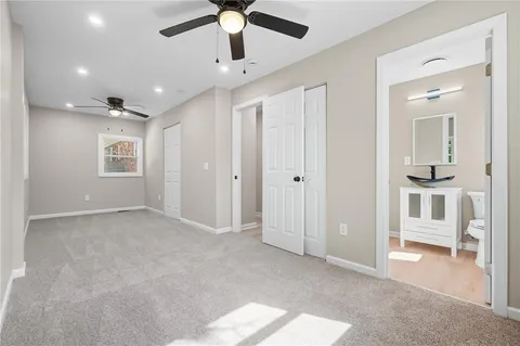 a view of empty room with wooden floor and ceiling fan