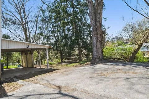 a backyard of a house with a tree