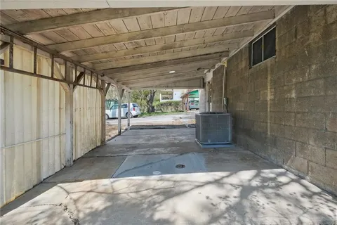 a view of a back yard with wooden fence
