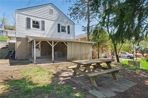 a backyard of a house with outdoor seating