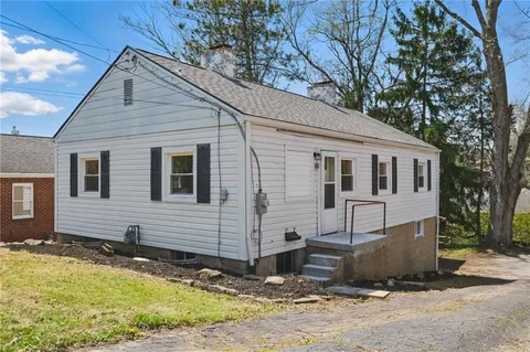 a view of a house with snow on the road