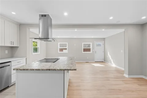 a kitchen with granite countertop sink and cabinets