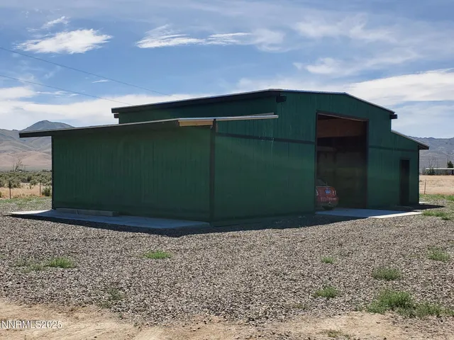 a view of a yard with wooden fence