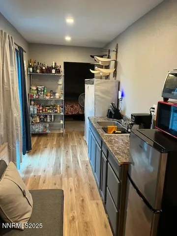 a kitchen with refrigerator and stove