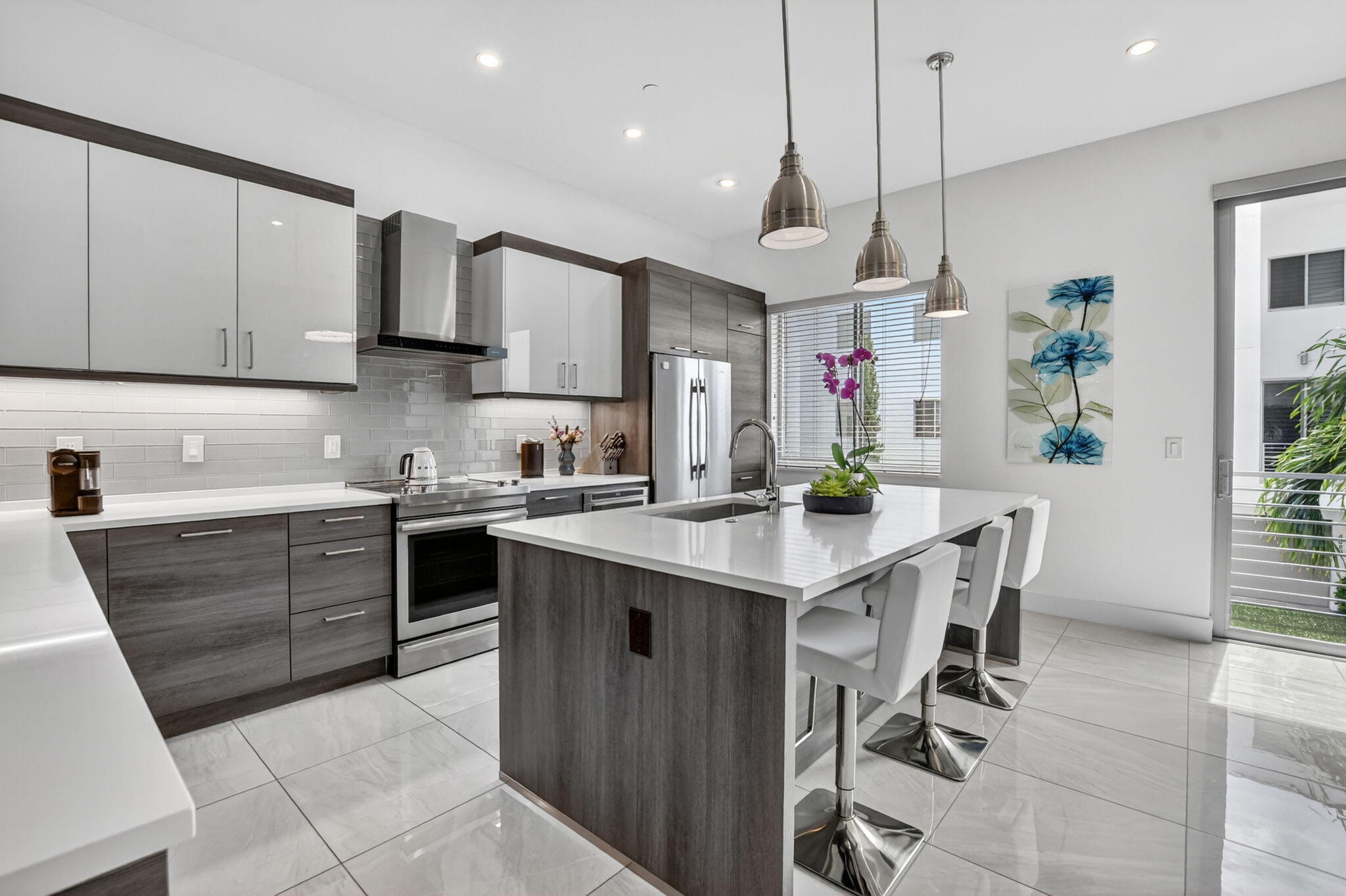4021 Northwest 18th Way Boca Raton, FL 33431 - Photo 14 of 37 a kitchen with stainless steel appliances kitchen island granite countertop a sink and cabinets