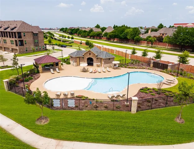 an aerial view of a house with a swimming pool yard and outdoor seating