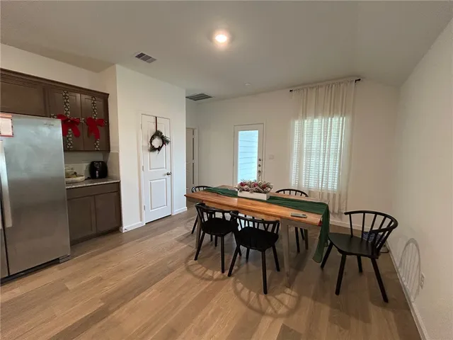 a kitchen with sink a stove and chairs