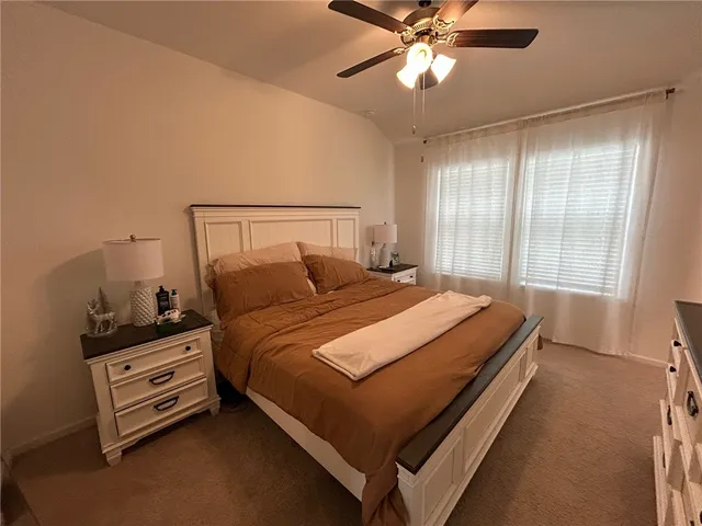 a kitchen with stainless steel appliances a dining table chairs and wooden floor