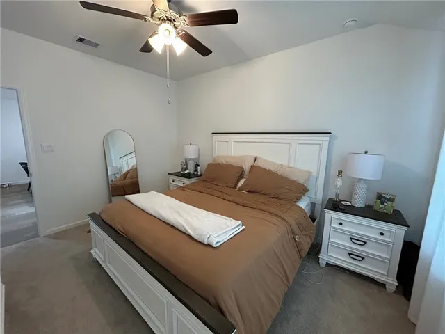 a bedroom with a bed and window