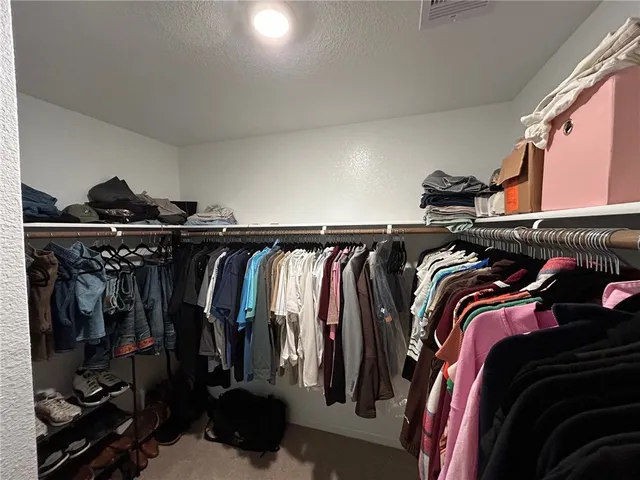 a en suite bathroom with a granite countertop sink and a mirror