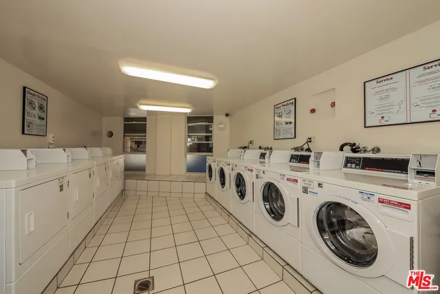 a view of a kitchen with sink washer and dryer