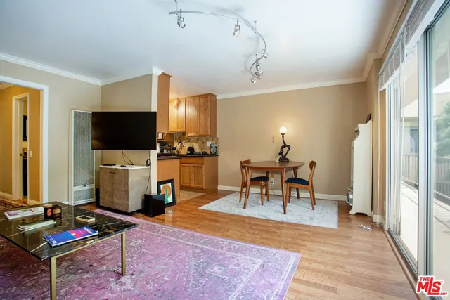 a living room with furniture a dining table and a flat screen tv