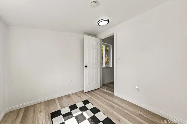 a view of a closet area with wooden floor