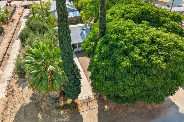 an aerial view of a house with a yard and lake view