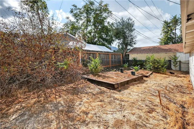 a view of a house with a yard and sitting area