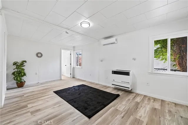 a view of a room with wooden floor and natural light