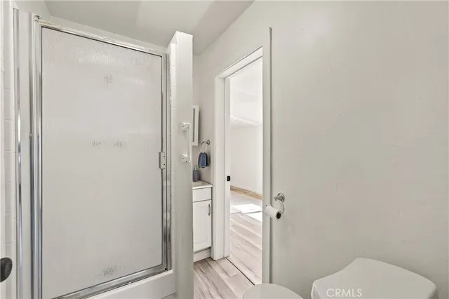 a bathroom with a glass shower door