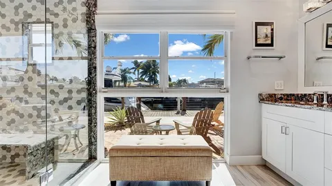 a bedroom with a bed and a dresser next to a window