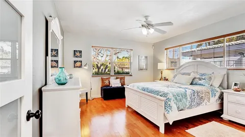 a bedroom with a large bed and a balcony