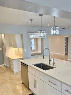 a kitchen with stainless steel appliances a refrigerator sink and cabinets