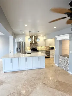 a kitchen with stainless steel appliances a refrigerator stove and cabinets