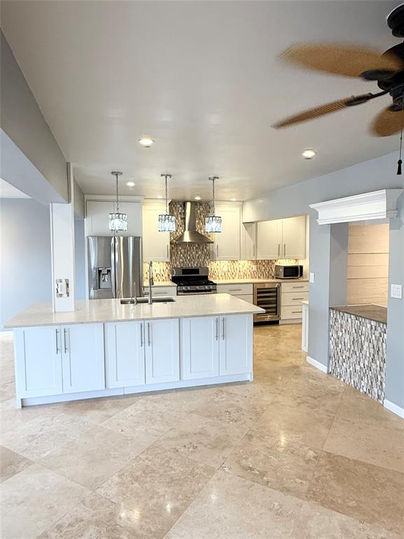 2524 Southeast 9th Street Pompano Beach, FL 33062 - Photo 34 of 45 a kitchen with stainless steel appliances a refrigerator sink and cabinets