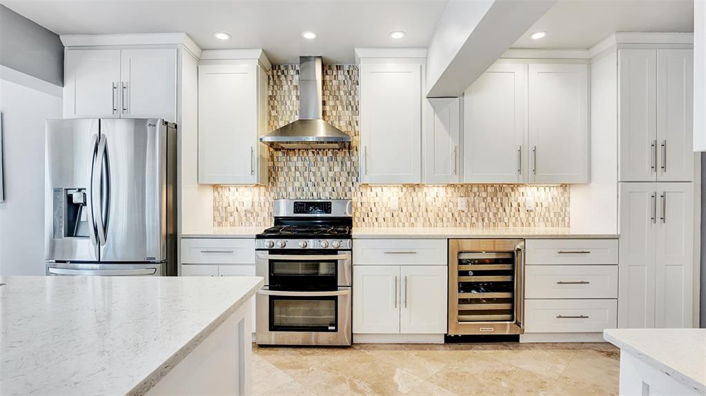 2524 Southeast 9th Street Pompano Beach, FL 33062 - Photo 35 of 45 a kitchen with stainless steel appliances a refrigerator stove and cabinets