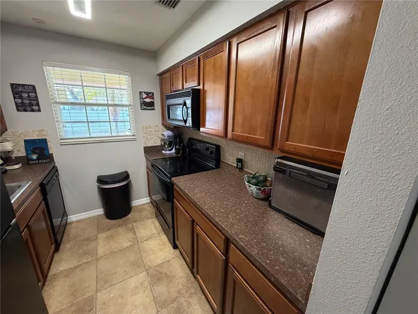 a kitchen with a sink stove and mirror