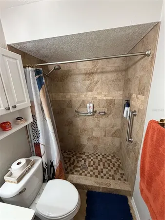 a bathroom with a toilet and shower