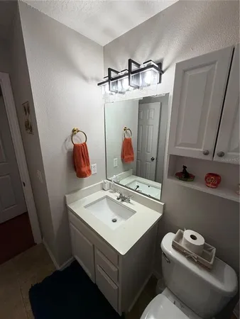 a bathroom with a sink vanity granite and a mirror