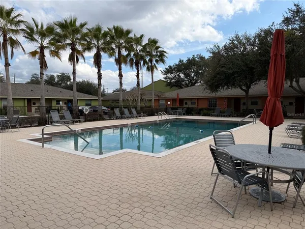 a view of a lake with table and chairs