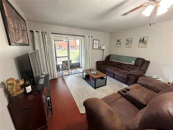 a living room with furniture rug and wooden floor