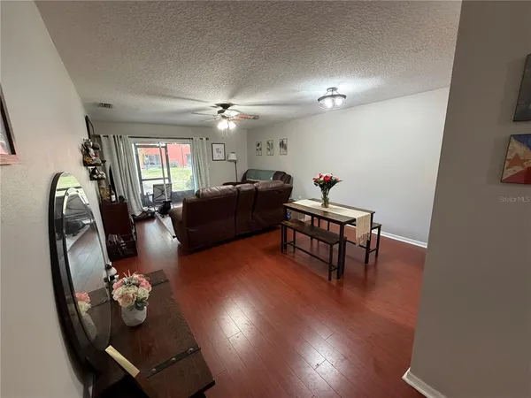 a living room with furniture and wooden floor