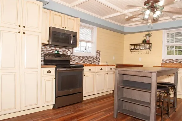 a kitchen with a refrigerator and a stove
