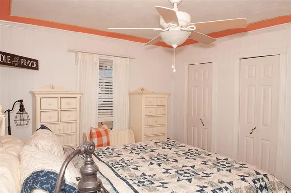 a bedroom with a bed and a window