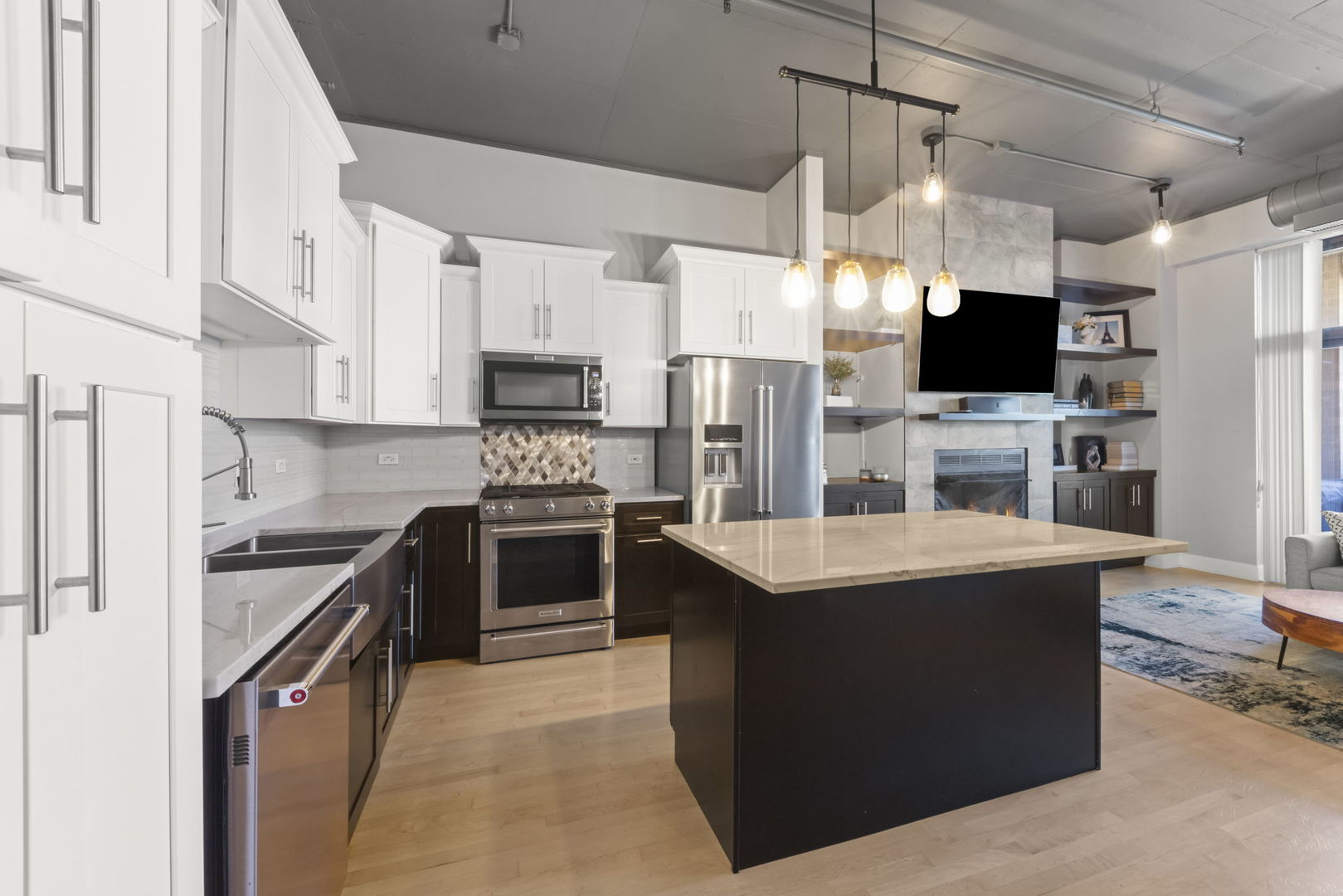 1301 West Madison Street, Unit 305 Chicago, IL 60607 - Photo 4 of 22 a kitchen with kitchen island a sink stove and refrigerator