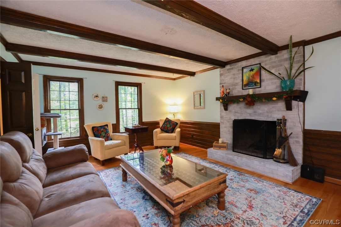 2000 Camborne Road Chesterfield, VA 23236 - Photo 16 of 44 Living room featuring beamed ceiling, a fireplace, hardwood floors, and natural light
