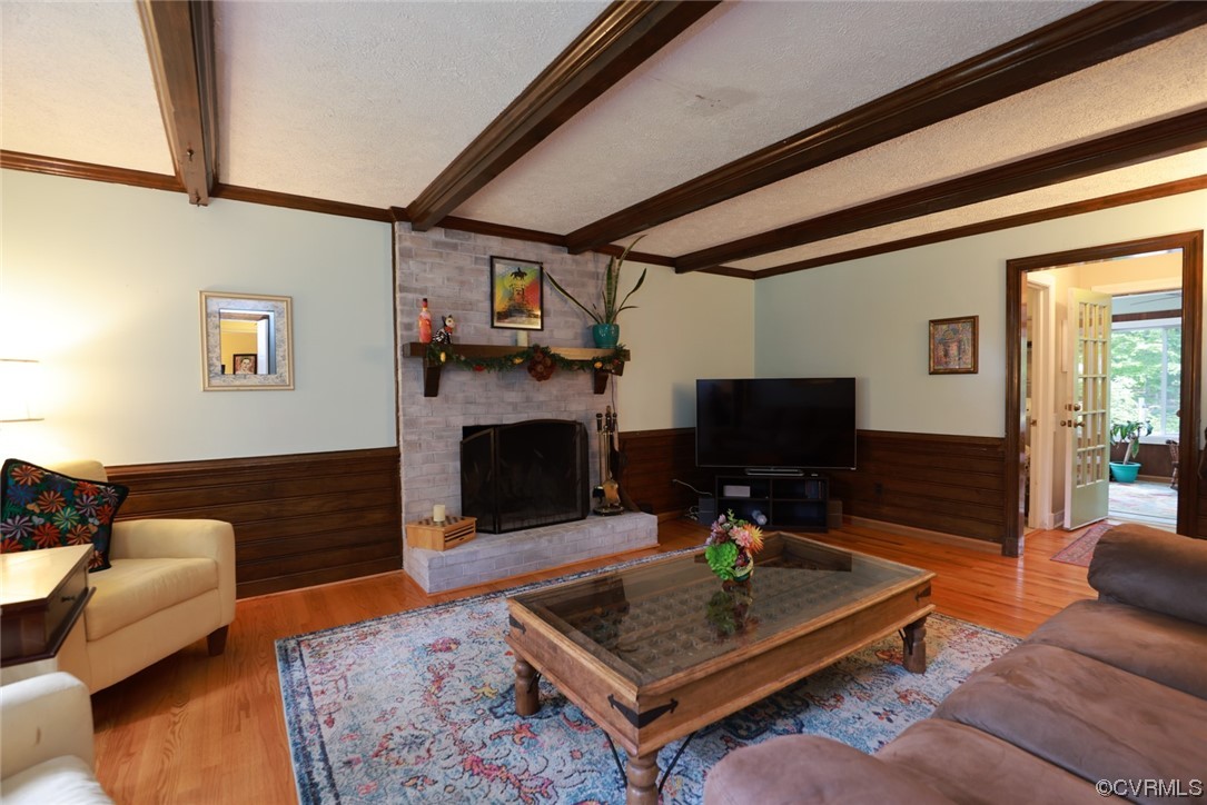 2000 Camborne Road Chesterfield, VA 23236 - Photo 17 of 44 Hardwood floored living room featuring a fireplace, beamed ceiling, and TV