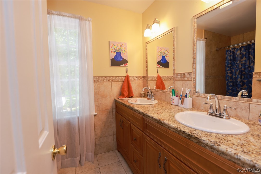 2000 Camborne Road Chesterfield, VA 23236 - Photo 24 of 44 Bathroom featuring tile floors, double sink vanity, shower curtain, and dual mirrors