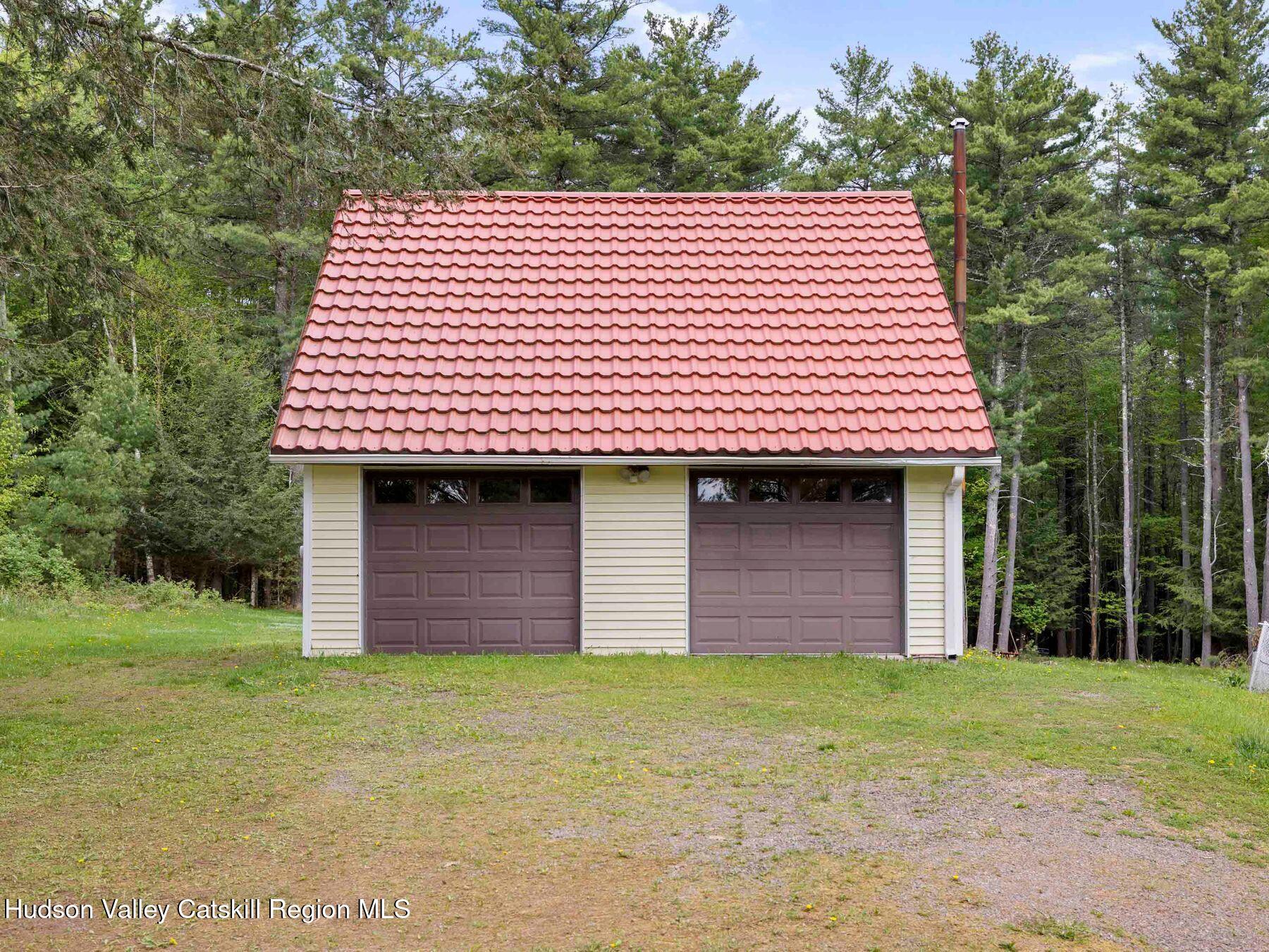 137 Mountain Pond View Road Gilboa, NY 12076 - Photo 8 of 38 a front view of a house with a garden