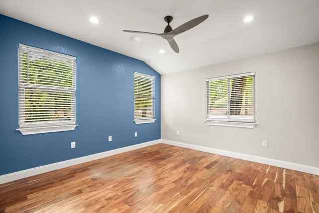 a view of a livingroom with a ceiling fan and window