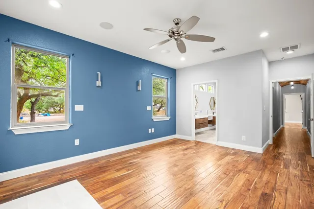 a view of a livingroom with a window and wooden floor
